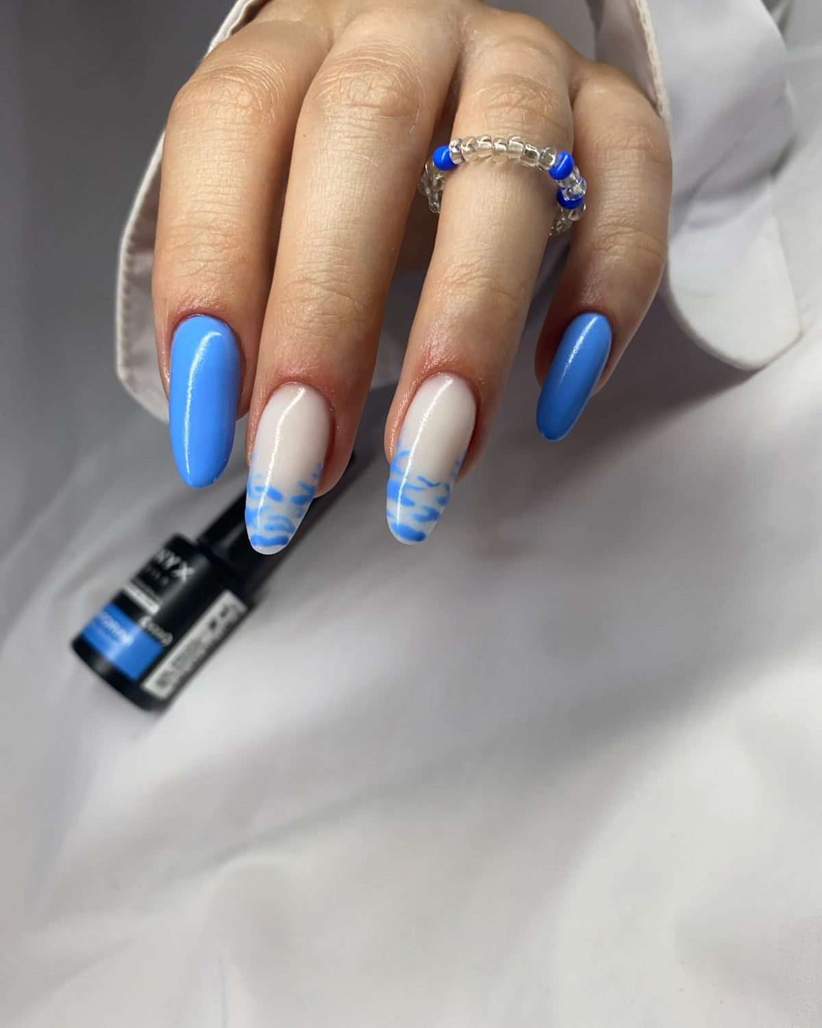 Blue nails with blue and white designs