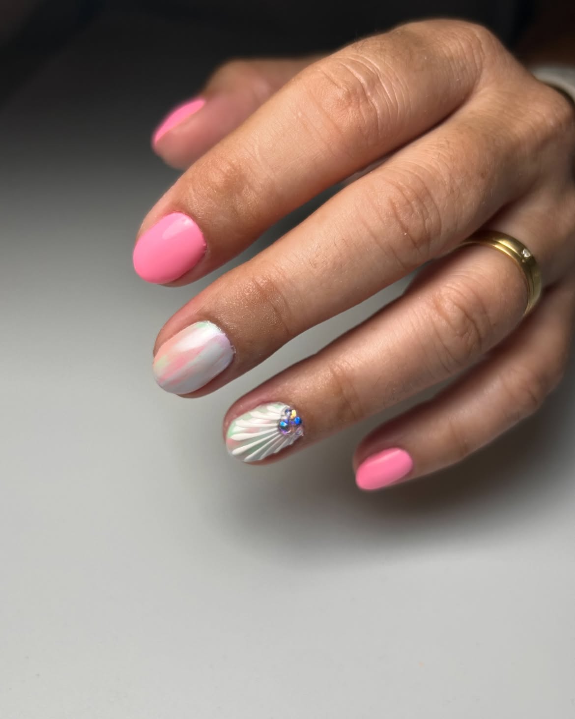 Pink nails with a seashell design