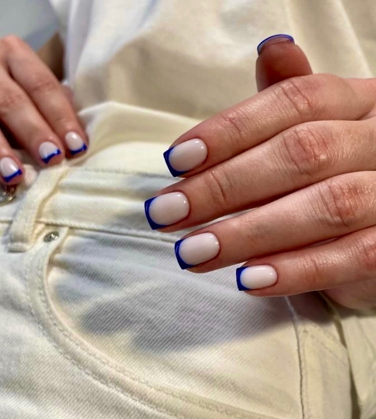 Nude nails with navy French tips