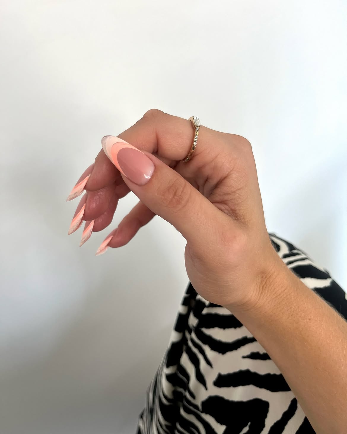 Long nude nails with pink French tips