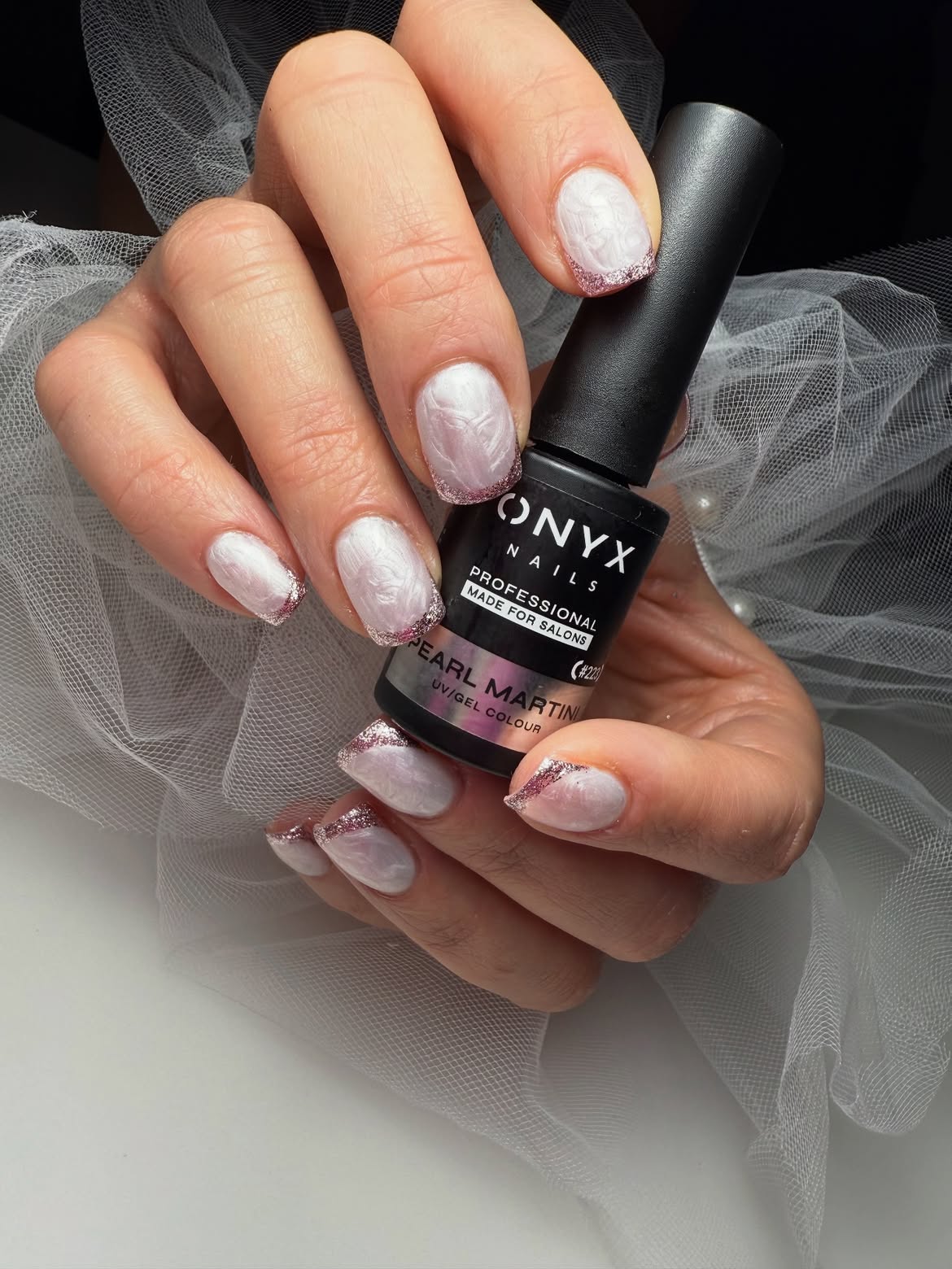 Milky nails with glitter and an ONYX bottle