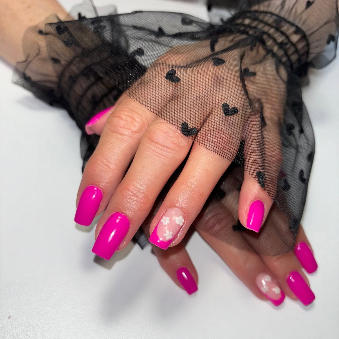 Fuchsia nails with a floral nail art accent
