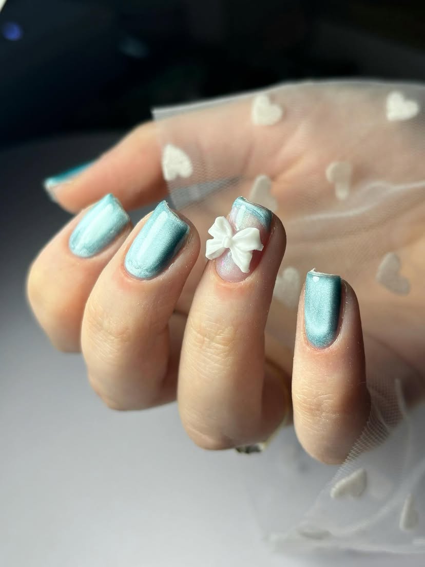 Light blue nails with a white bow